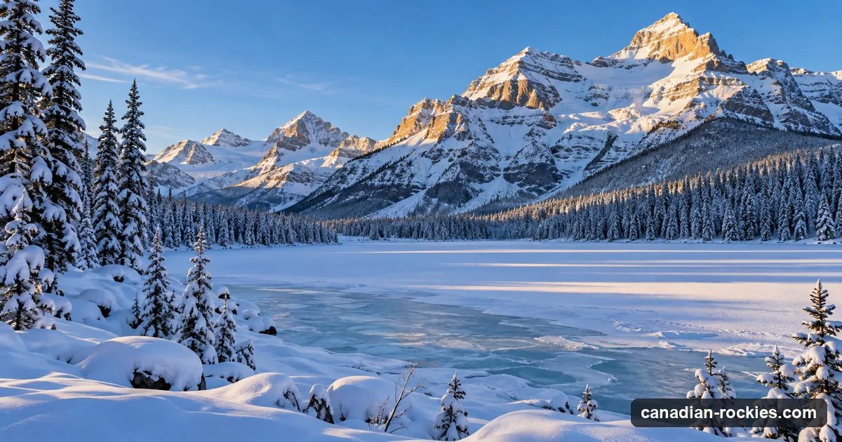 A frozen snow-covered mountain lake with snow-laden spruce and sunlit peaks